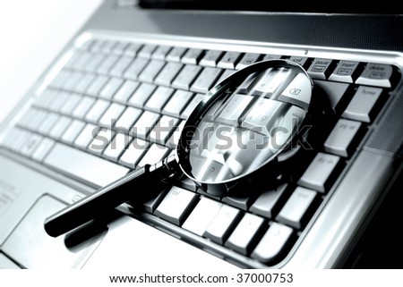 Laptop computer with magnifying glass, concept of search. Royalty-Free Stock Photo #37000753