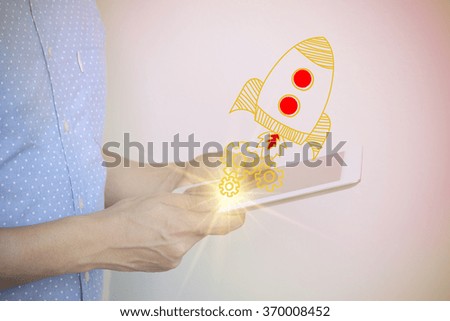young man holding tablet computer with start up concept , color filter image ,  business concept , business idea
