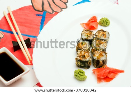 Fud art. Japanese sushi on a white plate on the tablecloth are made watercolor paint abstract image of human hands holding chopsticks