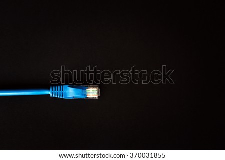 Blue patchcord with RJ45 plug lan network isolated on black background