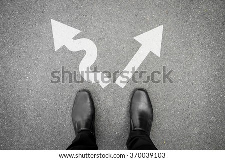 Black shoes standing at the crossroad and has to make decision which way to go for his success - hard way or easy way Royalty-Free Stock Photo #370039103