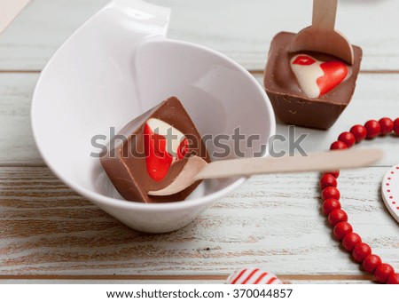 Hot chocolate and spoons with dark and white chocolate for party on old wooden table. dissolve in hot water = turn celebratory drink, Valentines day background, rustic style