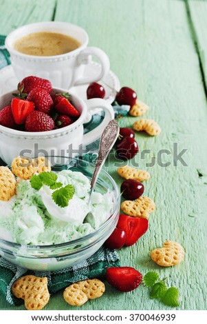 homemade ice cream of mint, a cup of coffee and fruit on the table. selective focus