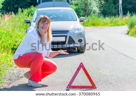 the driver of mature age and a broken car on the empty road