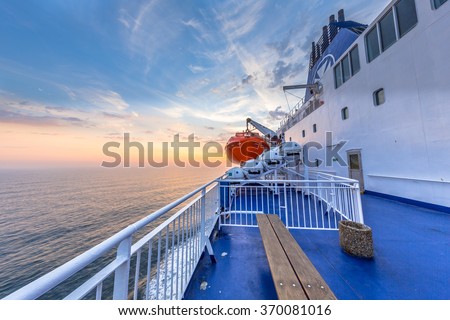 Deck on Ferry sailing across the Northsea during beautiful sunset Royalty-Free Stock Photo #370081016