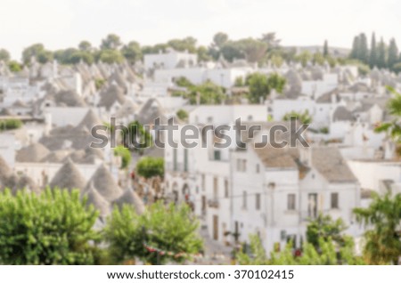 Defocused background with typical trulli buildings in Alberobello, Apulia, Italy. Intentionally blurred post production for bokeh effect