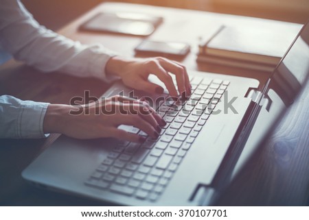 Working at home with laptop woman writing a blog. Female hands on the keyboard Royalty-Free Stock Photo #370107701