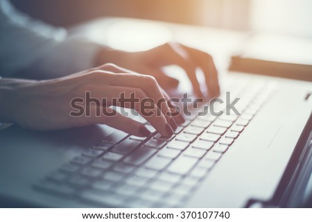 Working at home with laptop woman writing a blog. Female hands on the keyboard Royalty-Free Stock Photo #370107740
