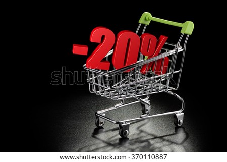 Shopping cart with 20 % percentage rate on a black textured background with copy-space