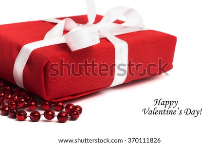 Tag Happy Valentine's Day with red present box and white ribbon isolated on white background 