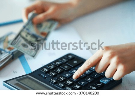 Woman working on financial report at the office, close-up