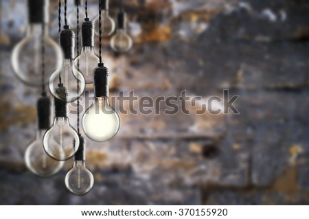 Idea and teamwork concept Vintage  bulbs on wall background,  copy space for text
