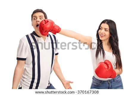Cheerful woman punching her boyfriend with boxing gloves isolated on white background