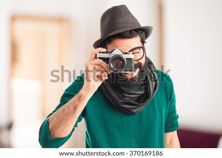 Man photographing on unfocused background