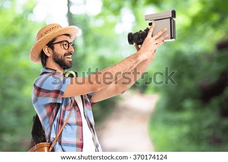 Tourist filming on unfocused background