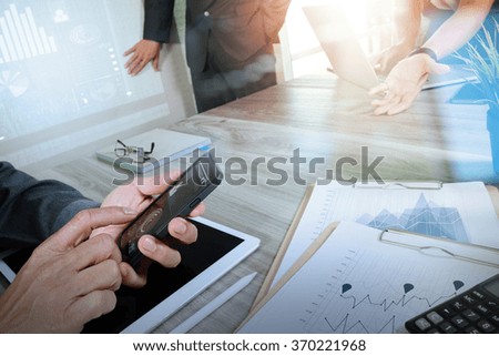 Medicine doctor hand working with modern computer and digital pro tablet with his team with  diagram on wooden desk as medical concept                               