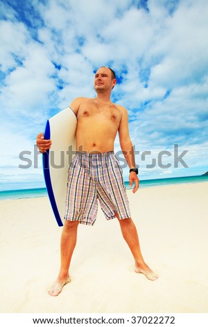 Man with body board on the tropical beach