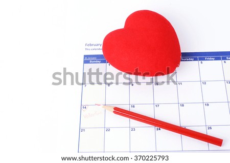 Red heart shaped and red color pencil on calendar white backgrounds for Valentine day