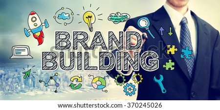  Businessman drawing Brand Building concept above the city