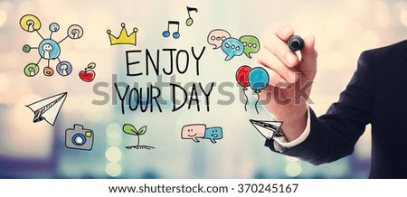 Businessman drawing Enjoy Your Day concept on blurred abstract background 