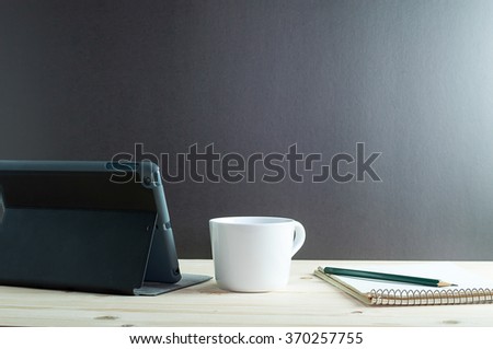 Workplace with tablet and coffee  on wooden desk. Royalty-Free Stock Photo #370257755