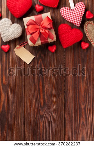 Valentines day background with handmaded hearts and candies over wood. Top view with copy space