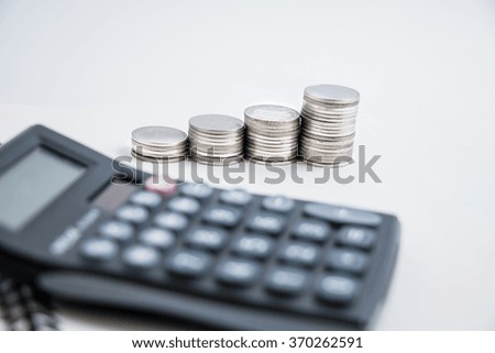 Select focus on coins set a graph and calculator. business concept for Success in business and financial .