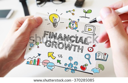 Mans hand drawing Financial growth concept on white notebook 