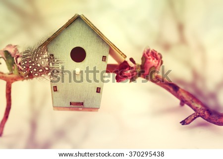 Spring background.Wooden feeder at the decorative tree.