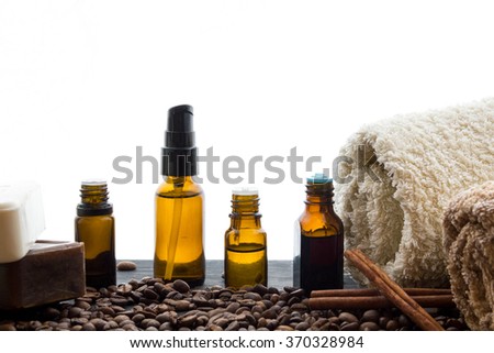 natural organic soap bottles essential oil and sea salt herbal bath  on a wooden table coffee background