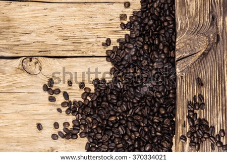 Coffee beans with smoke on wooden background