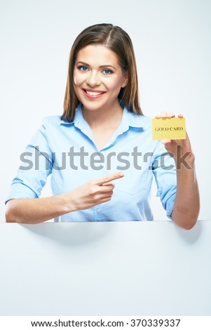 Smiling woman pointing finger to credit card. Isolated portrait.