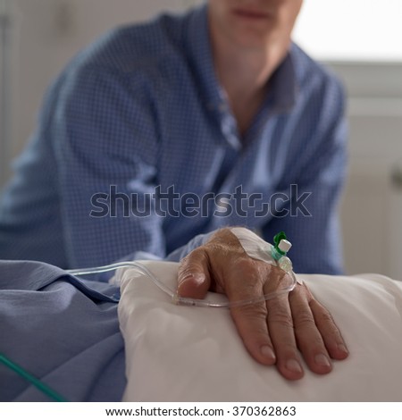Picture of patient and his relative sitting in the background
