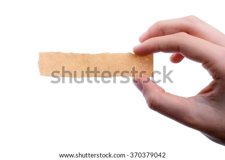 hand holding a piece of blank torn notepaper