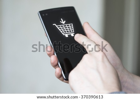 Businessman push button shopping cart online phone