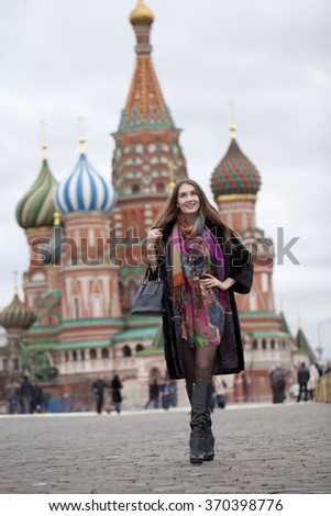 Portrait in full growth, Russian beautiful woman in a mink coat on the Red Square in Moscow