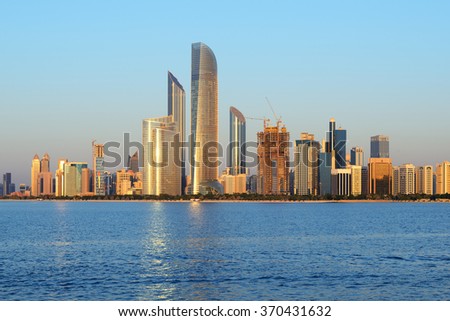 Abu Dhabi cityline at sunset. Royalty-Free Stock Photo #370431632