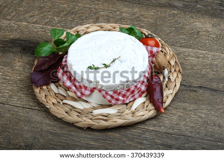 Camembert cheese with thyme and salad leaves