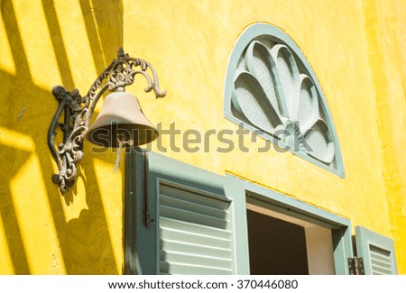Window on yellow cement with shadows, stock photo
