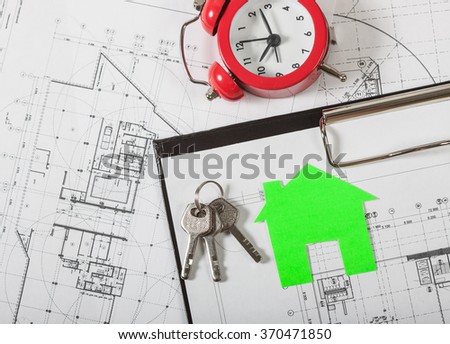 Model house on construction plan for house building, keys , red alarm clock and clipboard. Real Estate Concept.