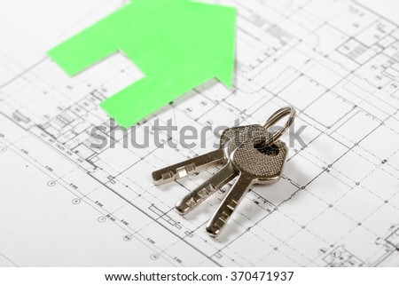 Model house on construction plan for house building with keys . Real Estate Concept.