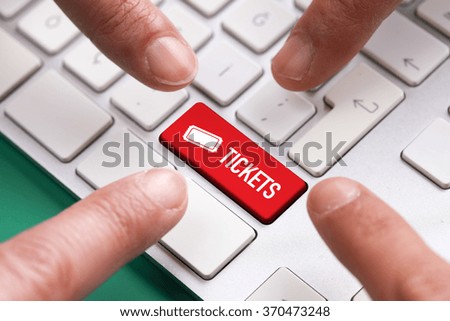 Computer Keyboard Concept: Many fingers pushing red Buy tickets key on the computer keyboard keyboard button