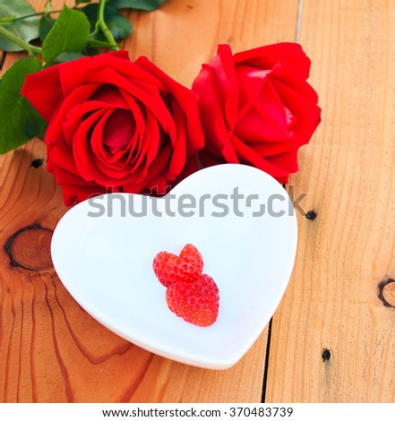 Red Strawberries heart shape with red rose on Valentine day