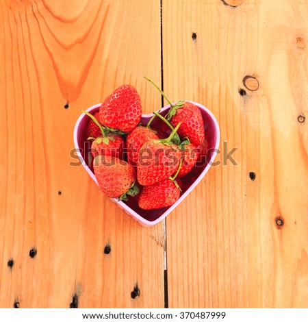 Red Strawberry in pink heart shape bowl on Valentine day