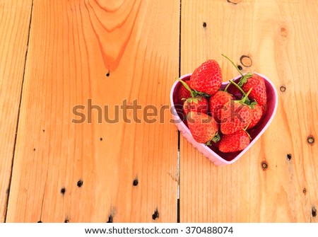 Red Strawberry in pink heart shape bowl on Valentine day