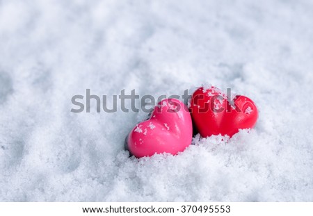 Red and pink chocolate heart on the snow
