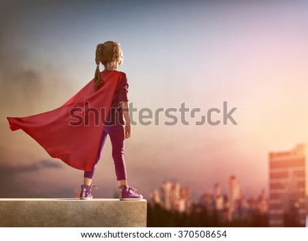 Little child girl plays superhero. Child on the background of sunset sky. Girl power concept Royalty-Free Stock Photo #370508654