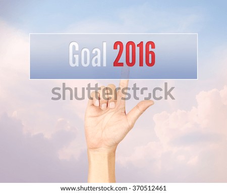 Goal 2016 concept with hand pressing a button on blurred abstract background with pantone color process