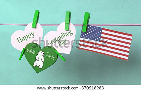 White hearts - cute face groundhog and text Happy Groundhog Day 2016 February 2. USA flag hanging on colorful pegs ( clothespin ) on a line against blue background.