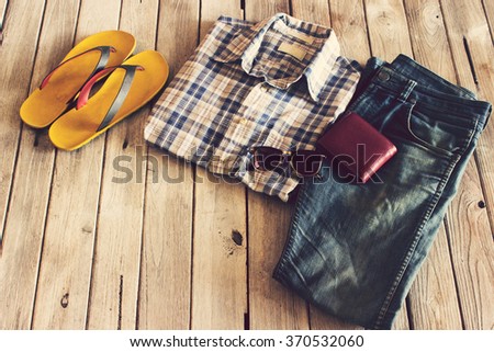 Vintage,Plaid shirt,Jean,slippers,Wallet and sunglasses on wood background